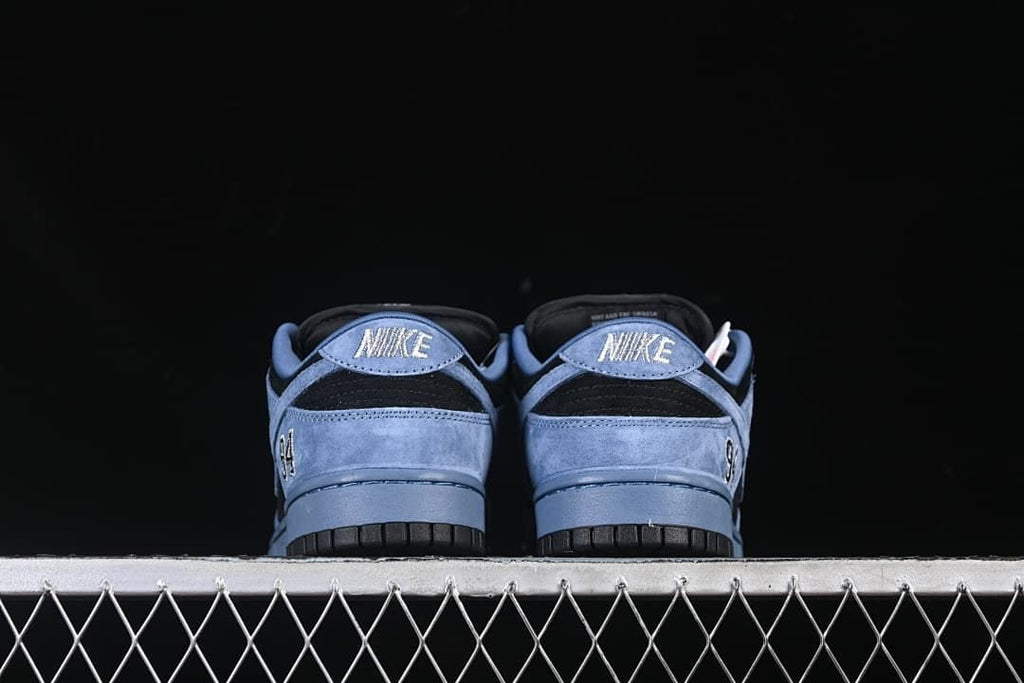 Rear view of both shoes showing Nike heel tabs and blue heel panels