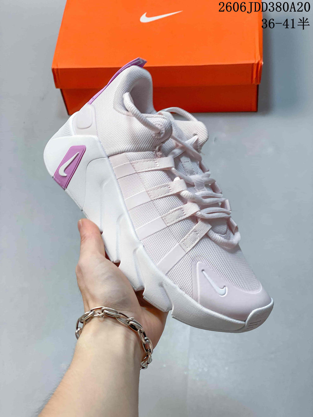 Angled side view of the white Nike Free Metcon 7 shoe with purple heel detailing