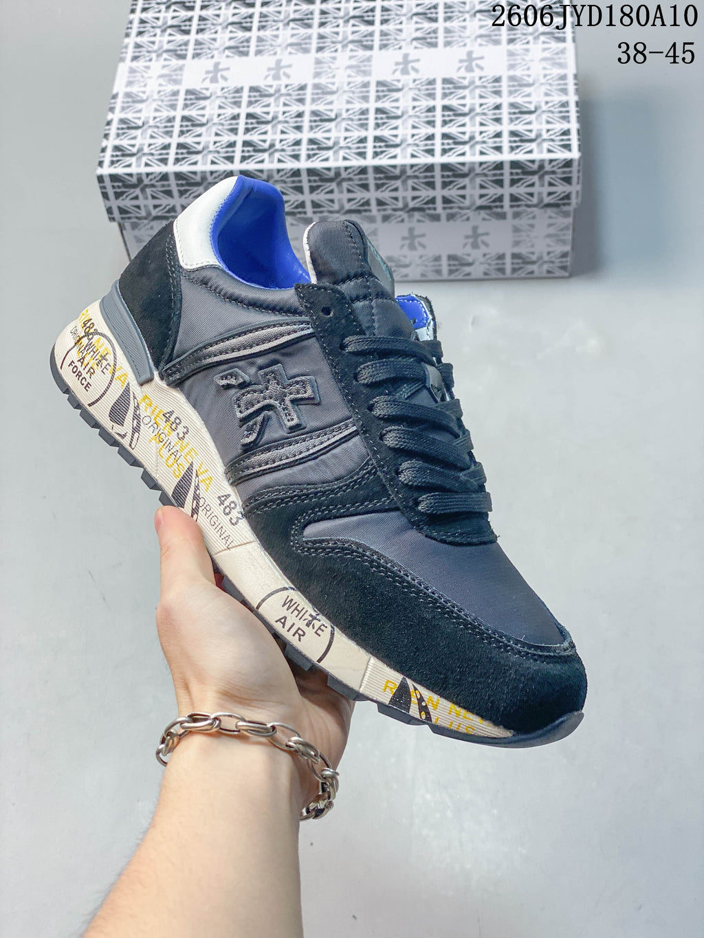 Angled side view of the trainer showing its side logo and patterned midsole