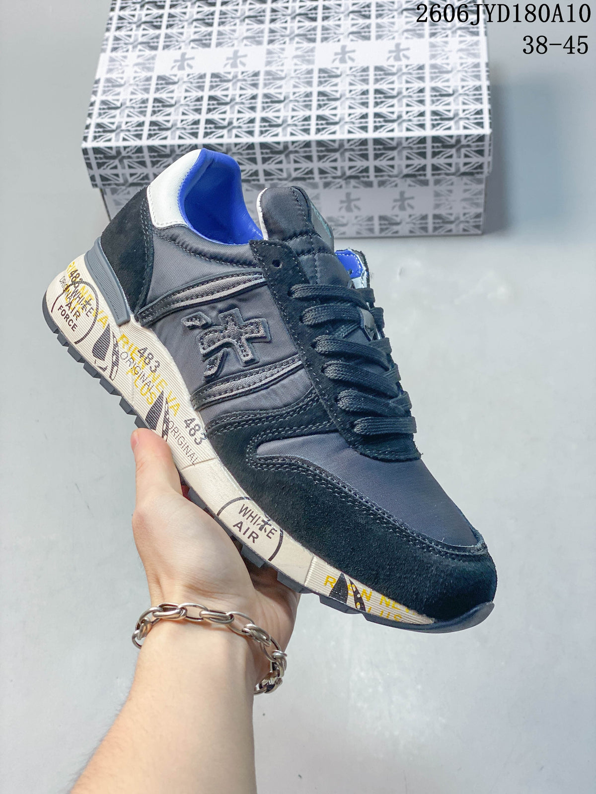 Angled side view of the trainer showing its side logo and patterned midsole
