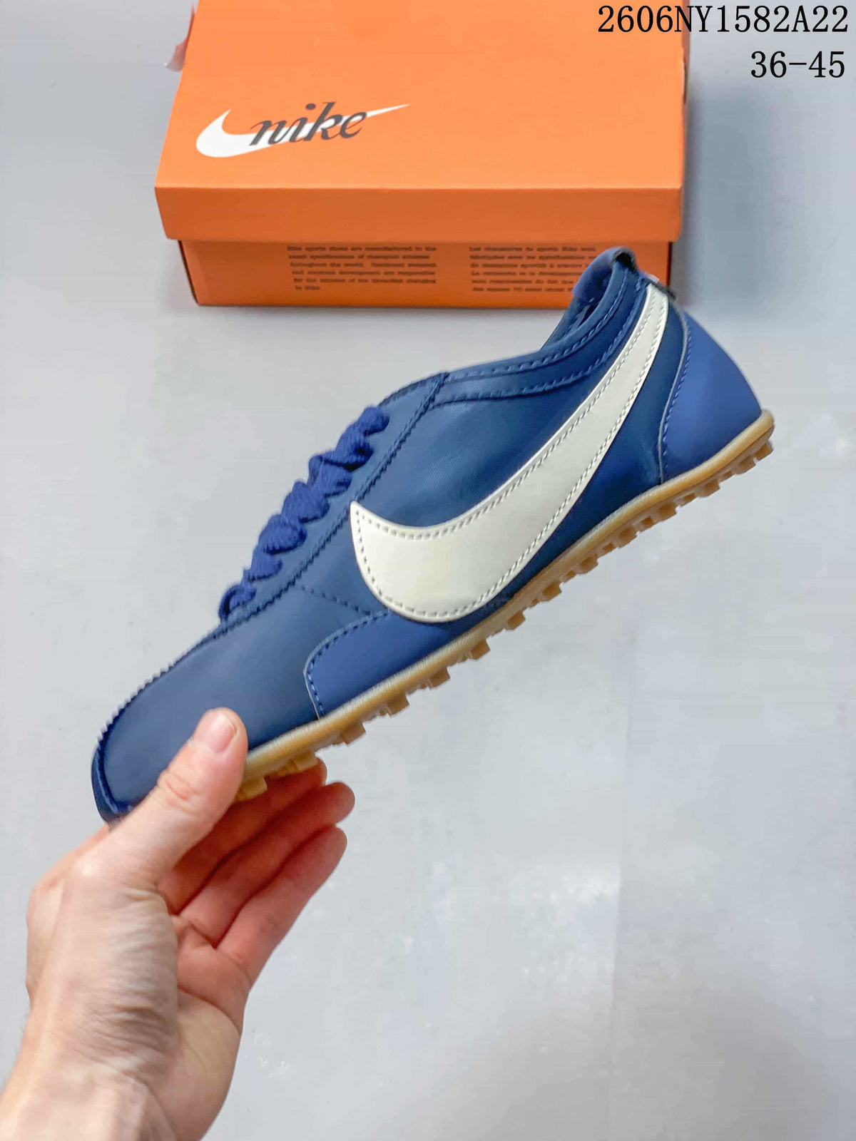 Side profile showing the blue upper, light-colored Swoosh, and gum outsole