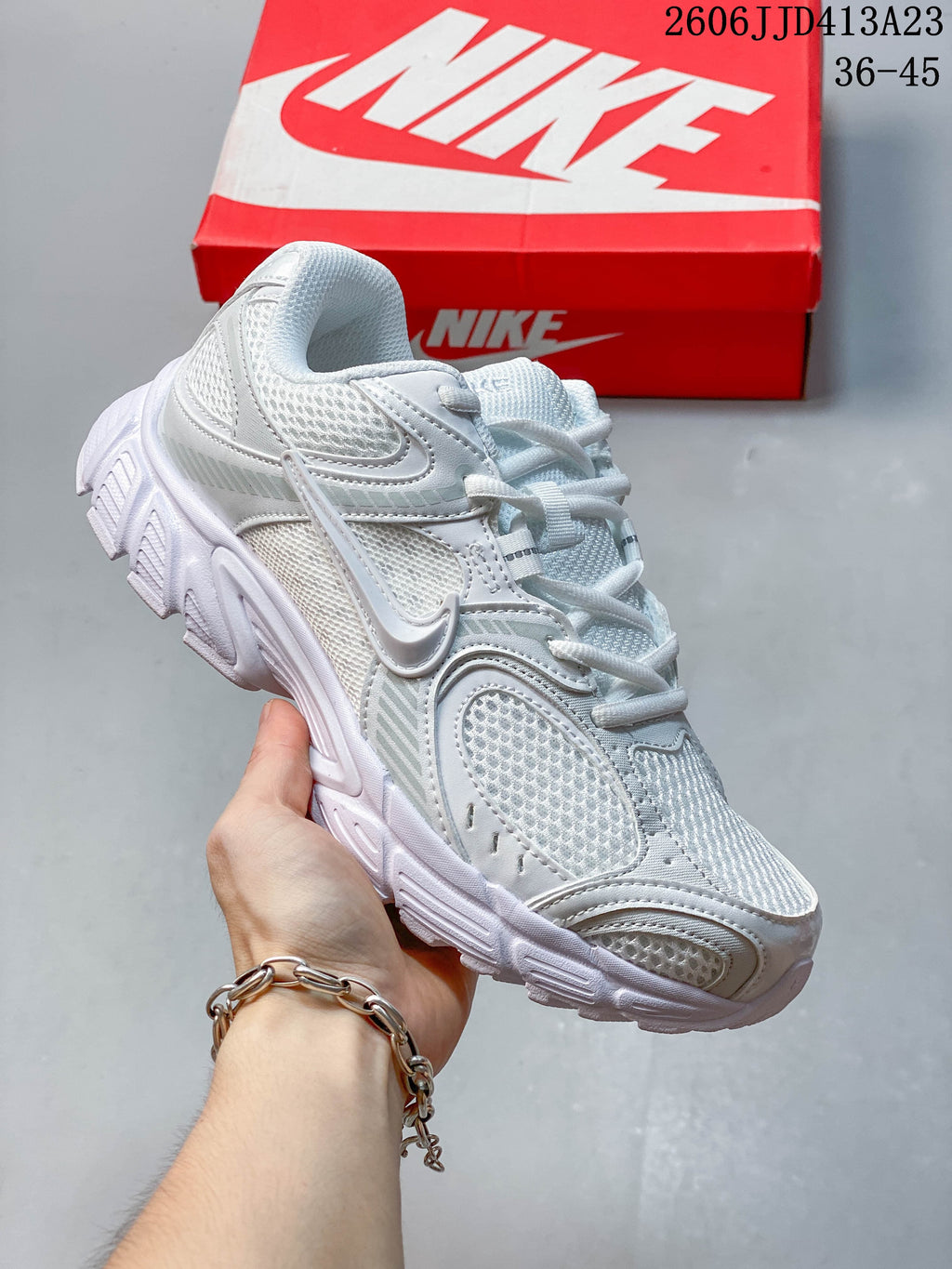 White Nike Air Zoom Winflo 12 sneaker with layered overlays and mesh panels.