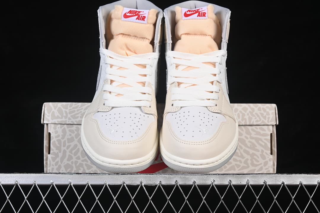 Front view of both sneakers positioned against the shoebox