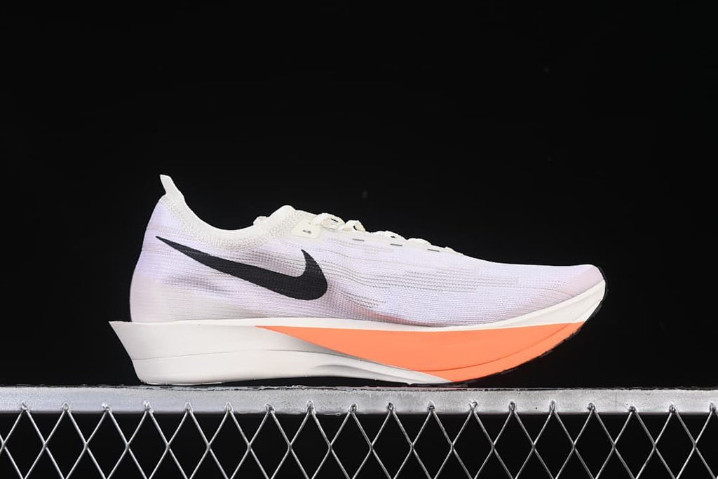 Side profile of the white running shoe with black side graphic and orange sole accent.