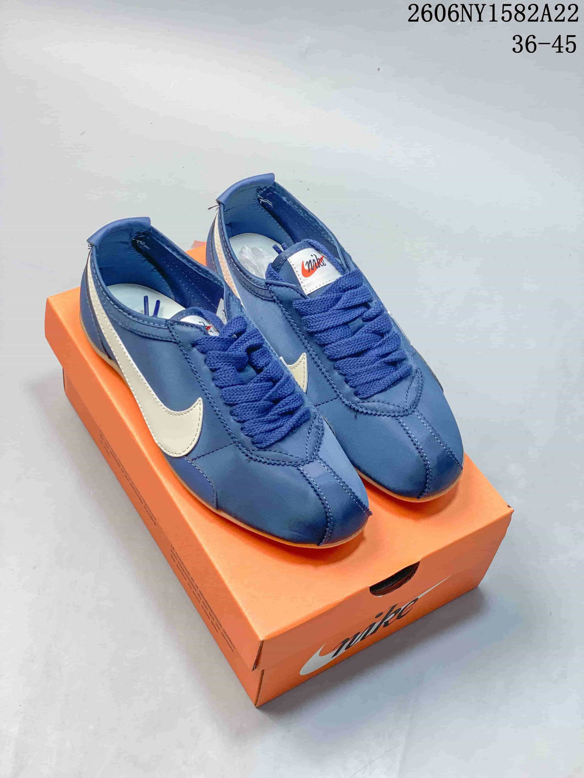 Pair of blue Nike Moon Shoe OG Summit low-top sneakers with light-colored Swoosh details and gum outsoles