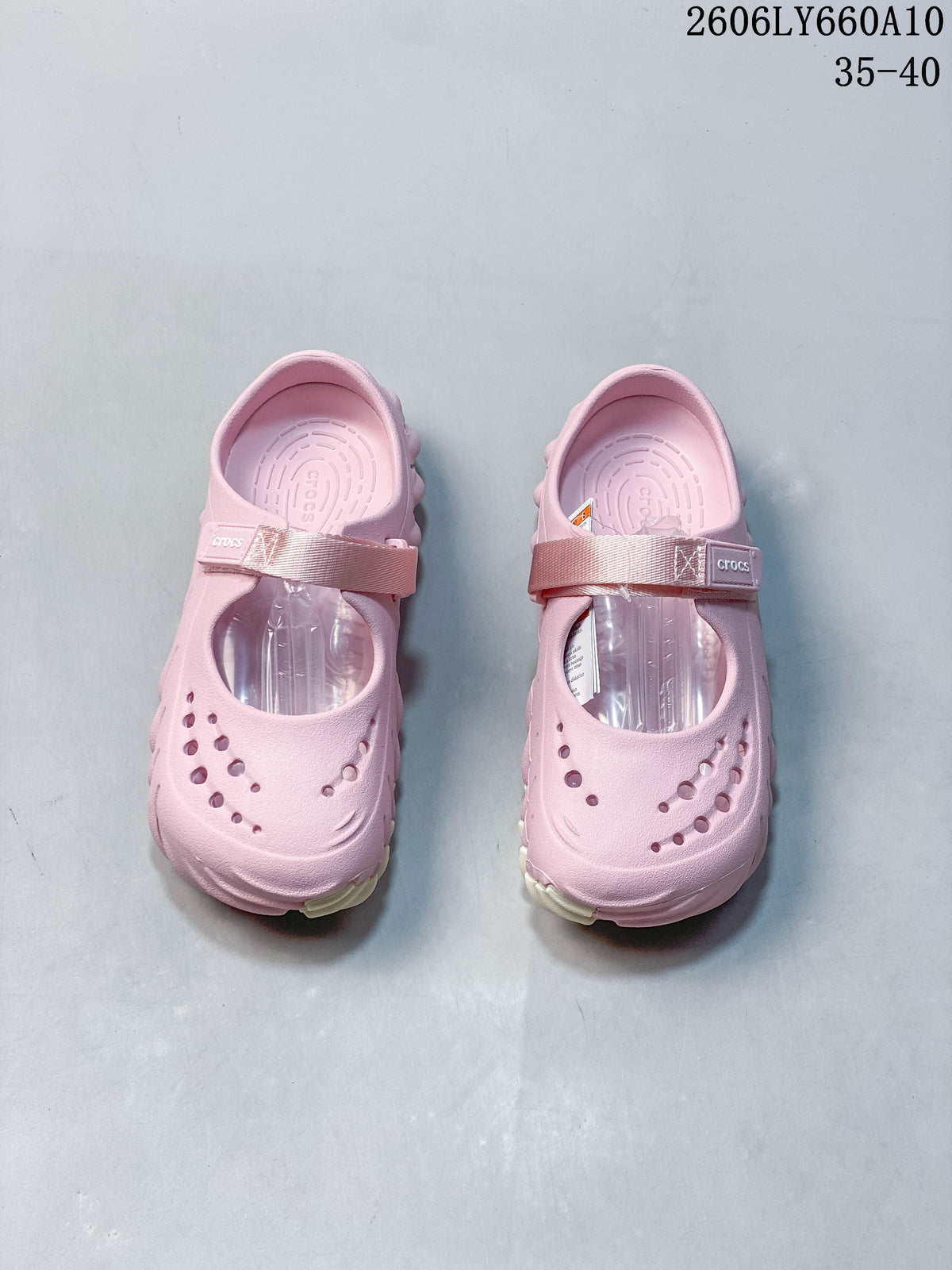 Pair of pink Crocs Mary Jane-style clogs viewed from above, with perforated toes and instep straps.
