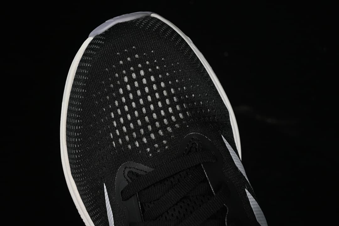 Top-down close-up of the patterned toe box and lace area.