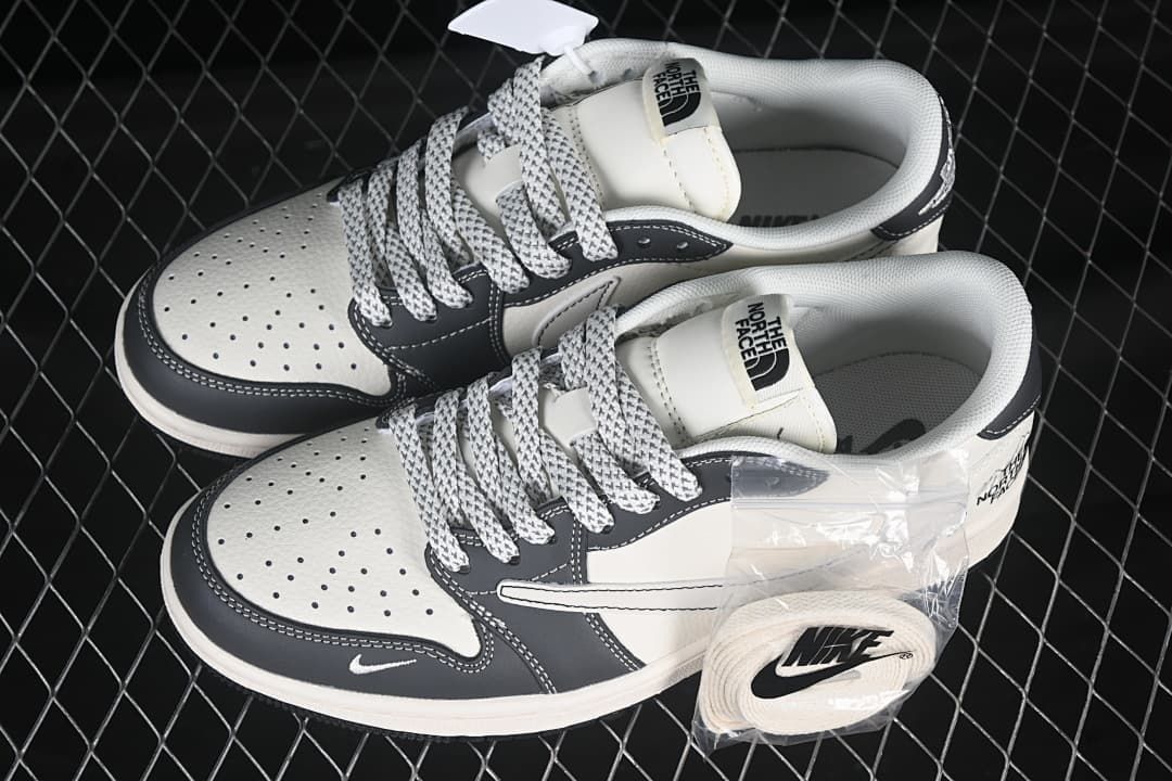 Pair of off-white and dark gray low-top sneakers shown from above, with perforated toe panels and an extra lace set.