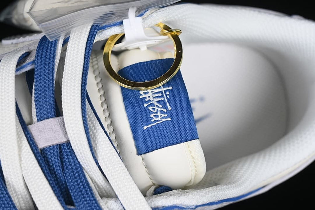 Close-up of the blue tongue detail, laces, and gold-tone charm