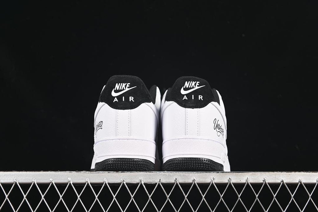 Rear view of the pair showing black heel tabs and Undefeated side details