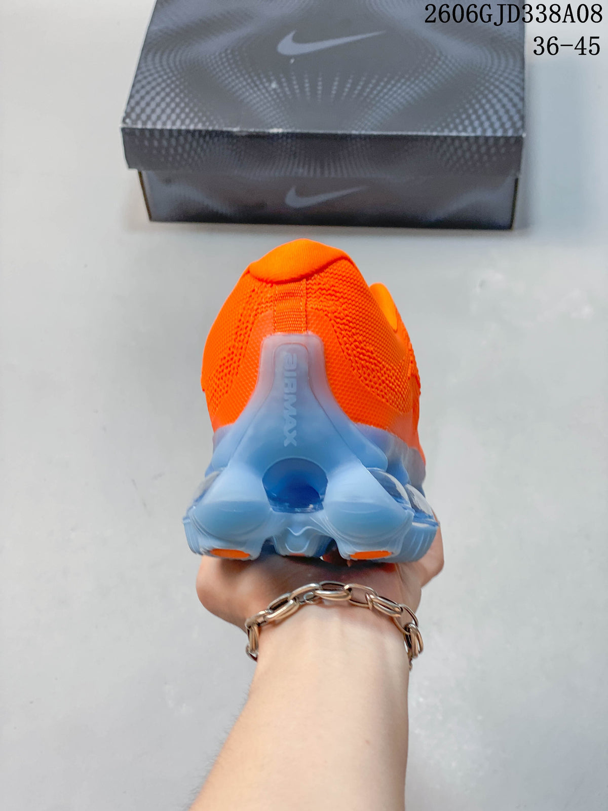 Rear view of the orange shoe and translucent blue heel structure.