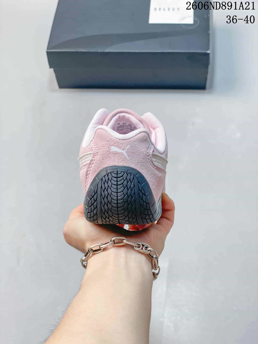 Rear view of a pink Puma Speedcat OG sneaker showing the heel and outsole