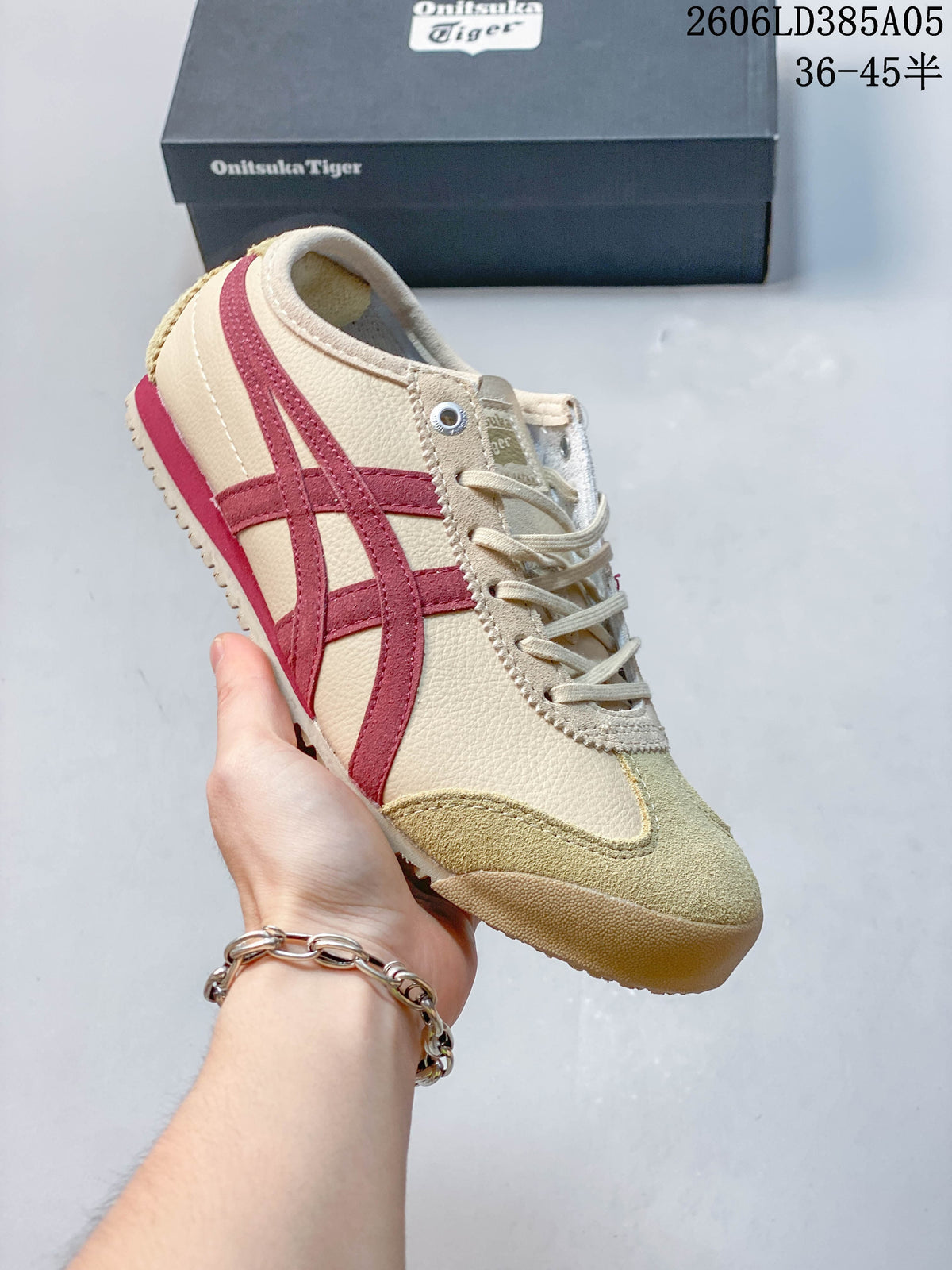 Angled side view of the beige and burgundy low-top sneaker