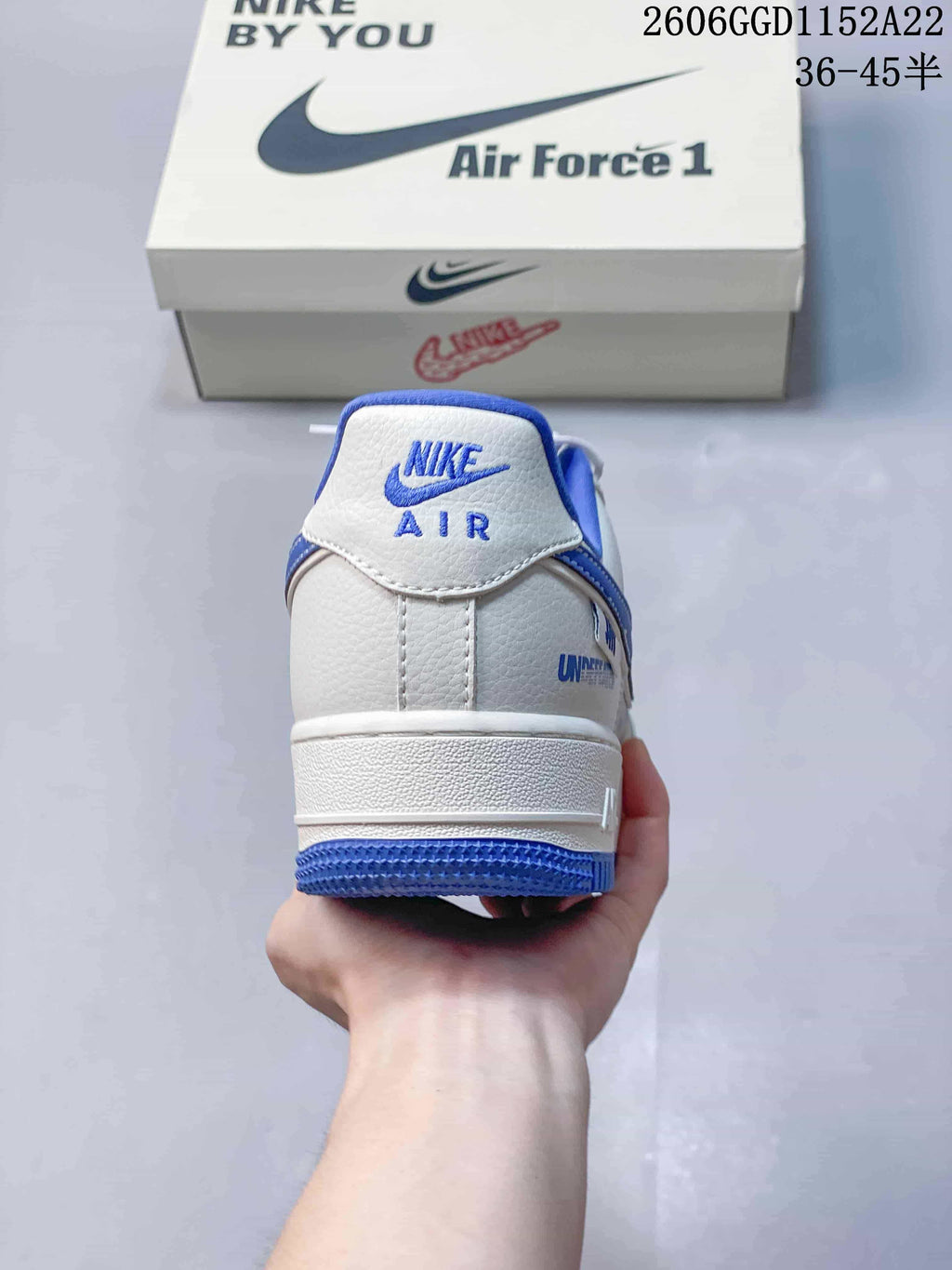 Heel view of a white and blue Air Force 1 sneaker