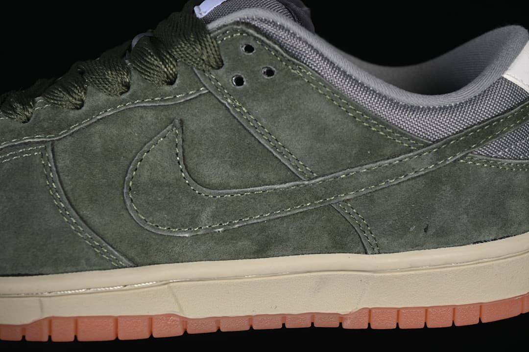 Close-up of the olive-green side Swoosh, stitching and gum-toned outsole