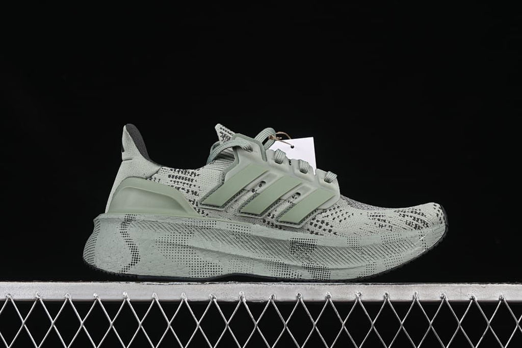 Side profile showing the patterned upper, three stripes and raised midsole