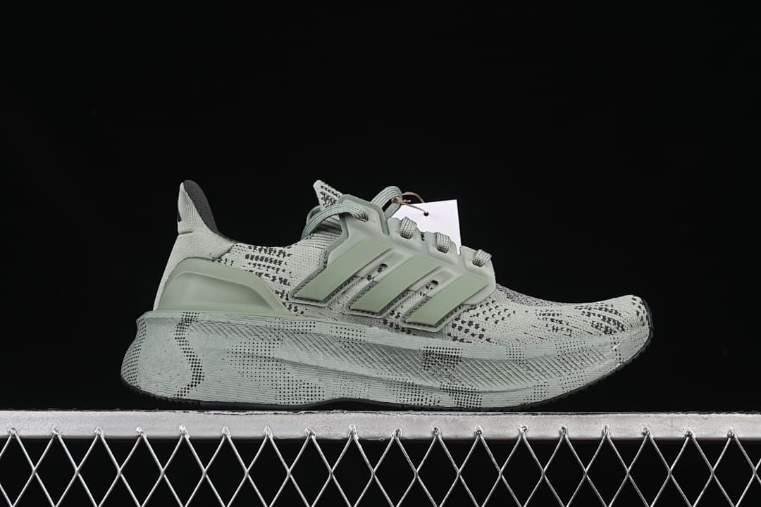 Side profile showing the patterned upper, three stripes and raised midsole