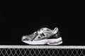 Side view of a silver and black New Balance 1906R kids sneaker with a hook-and-loop strap
