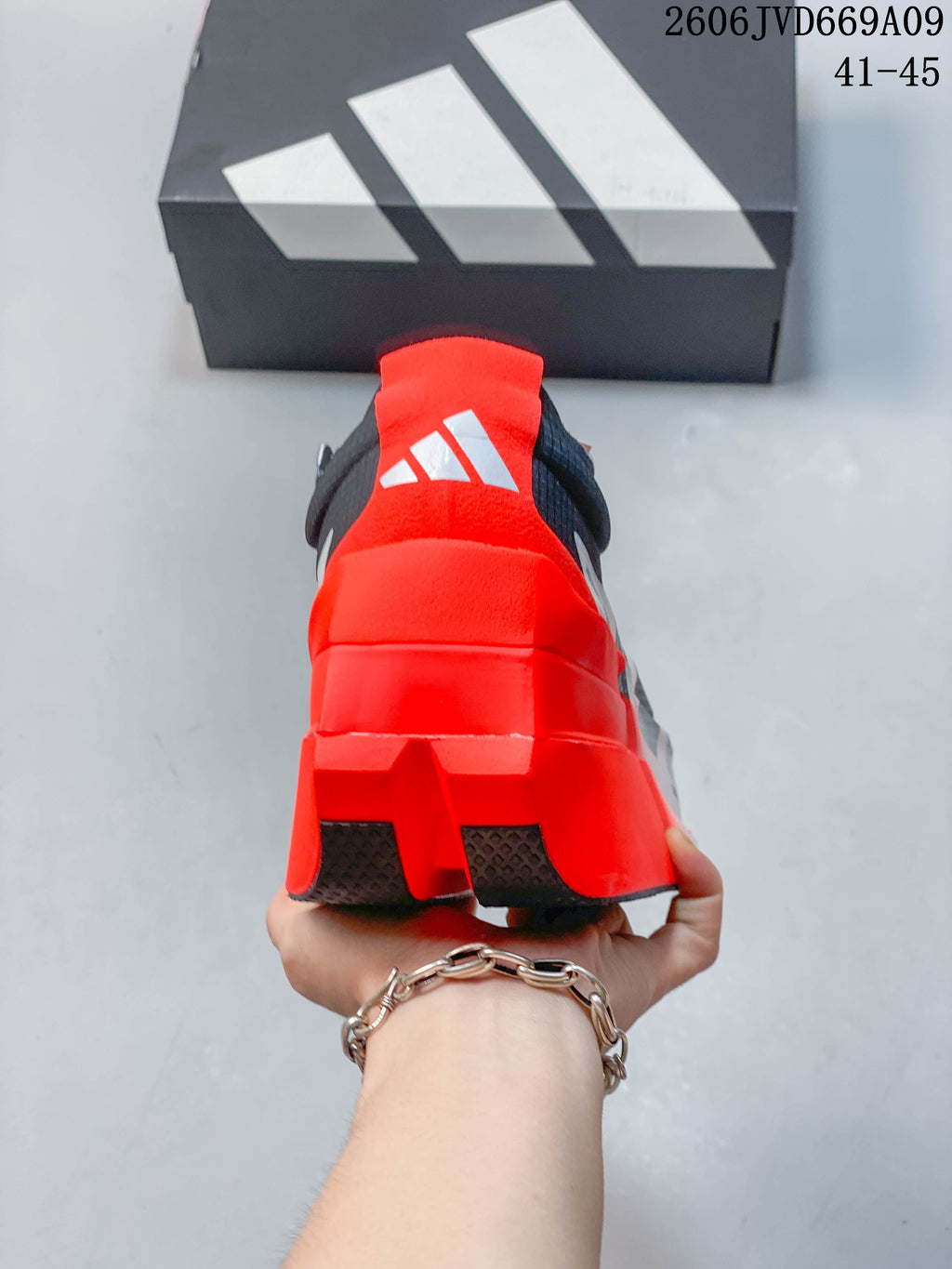 Rear view showing the bright red heel and adidas logo