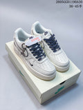 Pair of white Nike Air Force 1 ’07 LV8 low-top sneakers with dark patterned laces on a shoebox