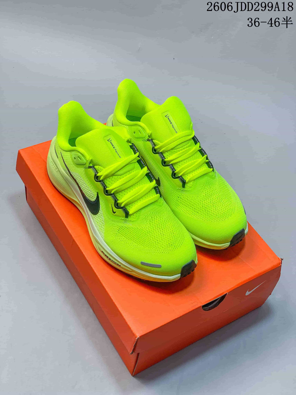 Pair of neon yellow Nike running shoes with dark Swoosh details