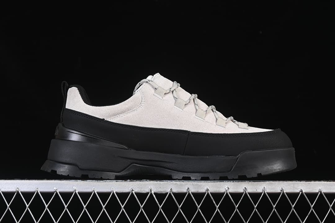 Side profile of a light grey and black low-top shoe