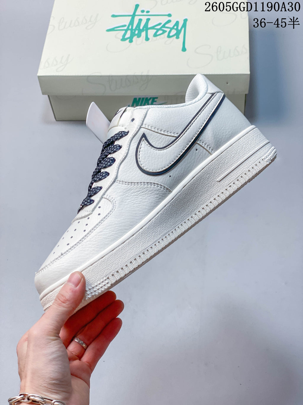 Side view of a white low-top sneaker with contrasting swoosh detail