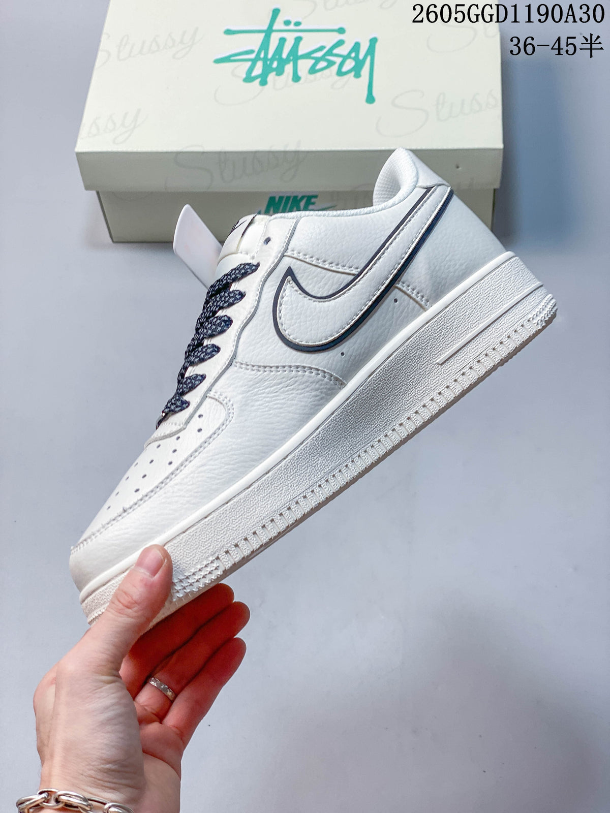 Side view of a white low-top sneaker with contrasting swoosh detail