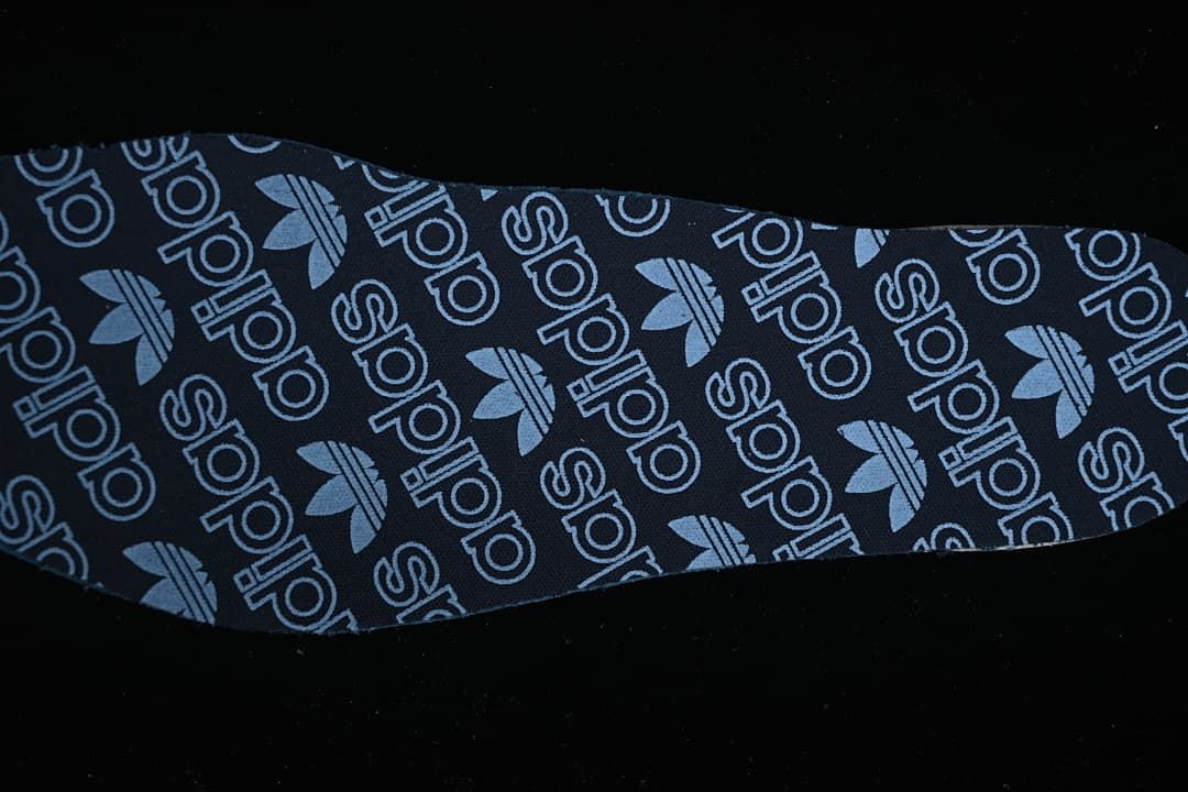 Close-up of a dark insole with adidas and Trefoil graphics