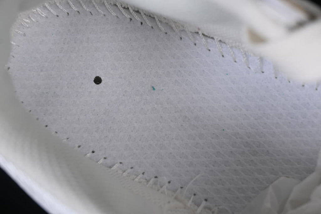 Close-up of the sneaker's light-colored inner lining and stitching
