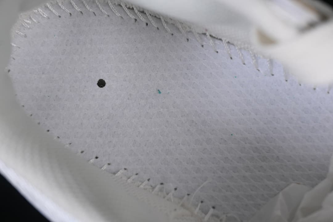 Close-up of the sneaker's light-colored inner lining and stitching