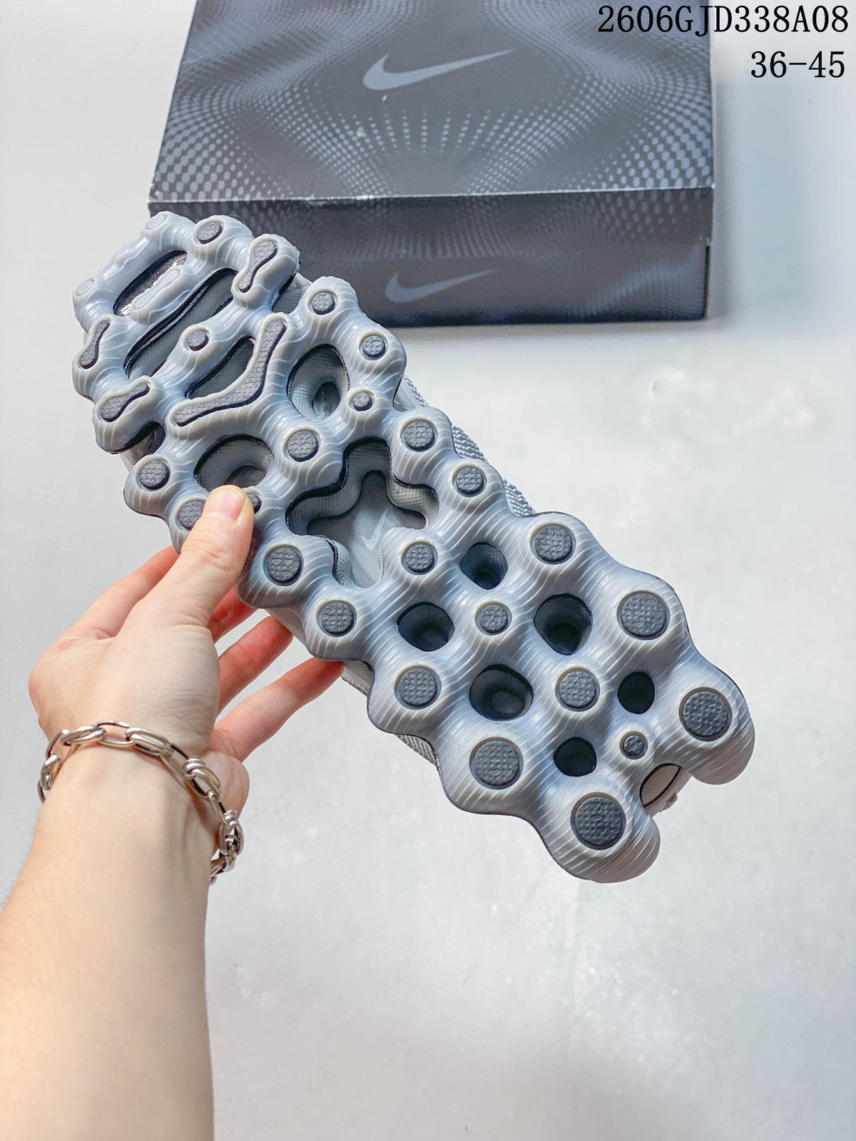 Underside of a Nike Air Liquid Max sneaker showing a sculpted sole with rounded segments