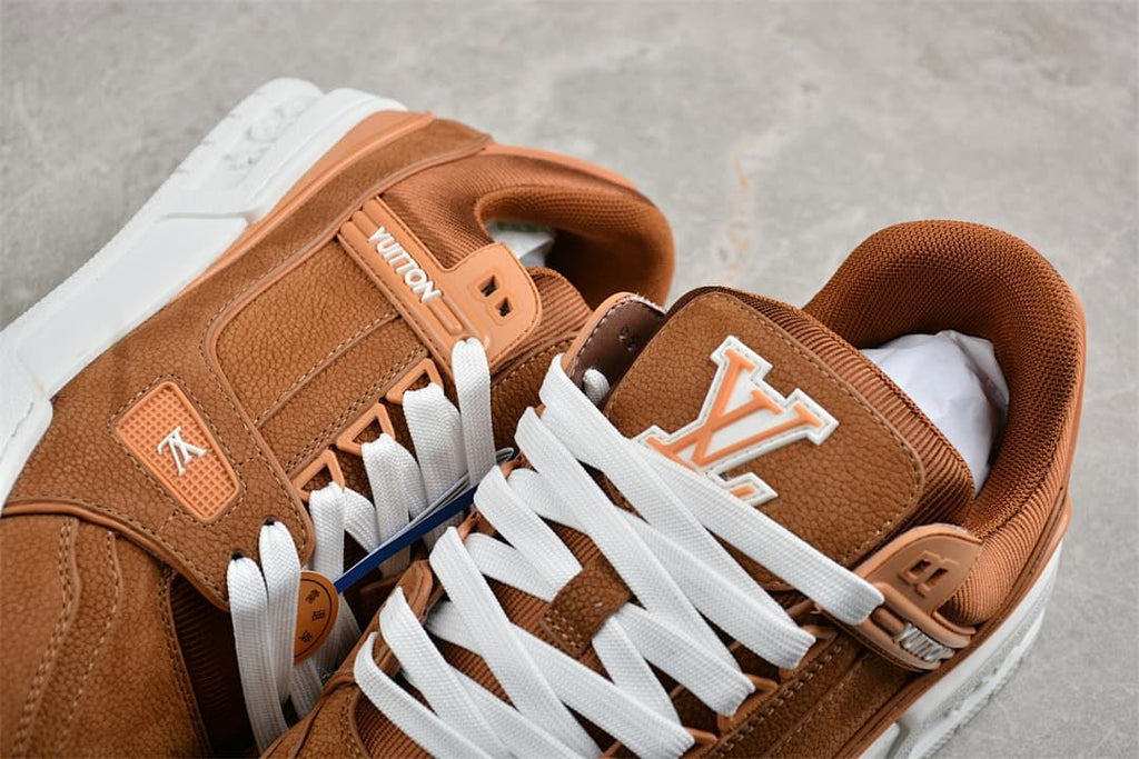 Close-up of brown LV Trainer sneakers showing white laces and logo details
