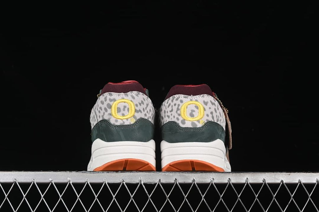 Rear view of both sneakers showing patterned heel panels and yellow details.