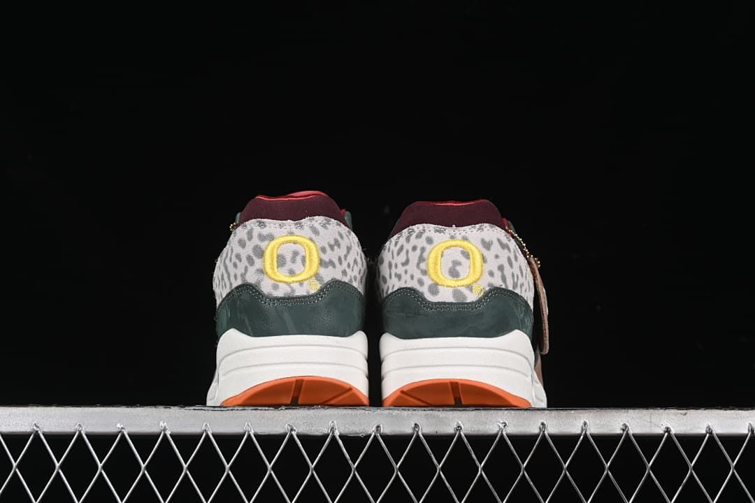 Rear view of both sneakers showing patterned heel panels and yellow details.