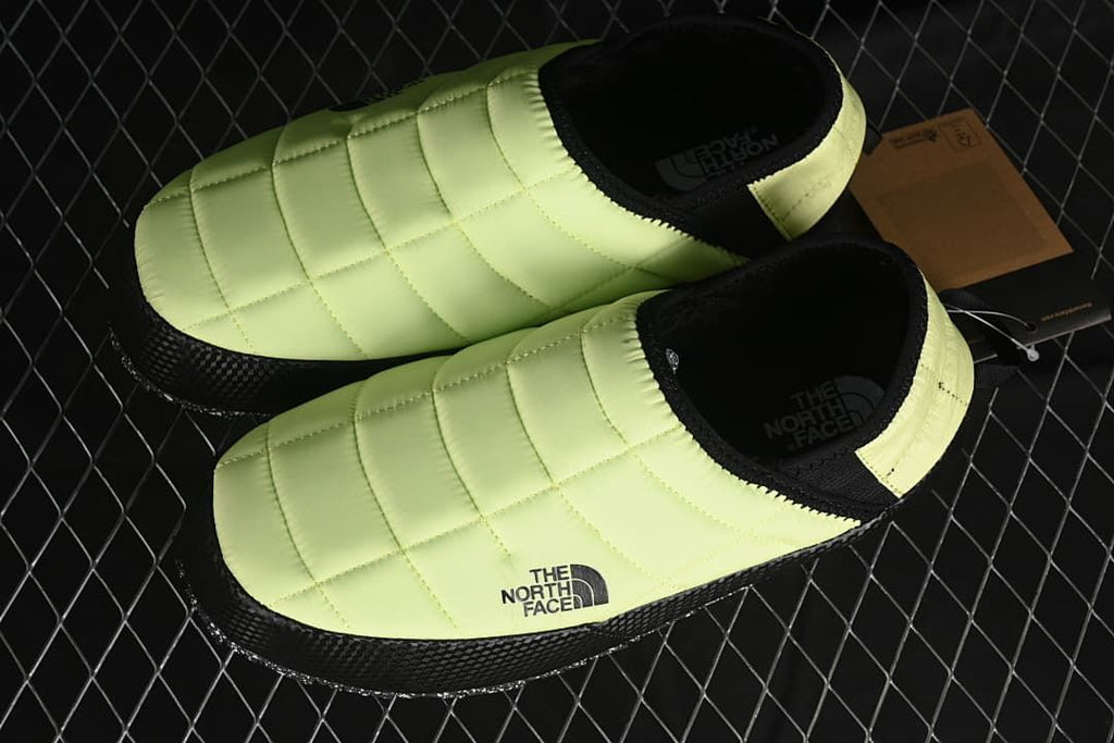 Pair of yellow and black slip-on shoes shown from above.