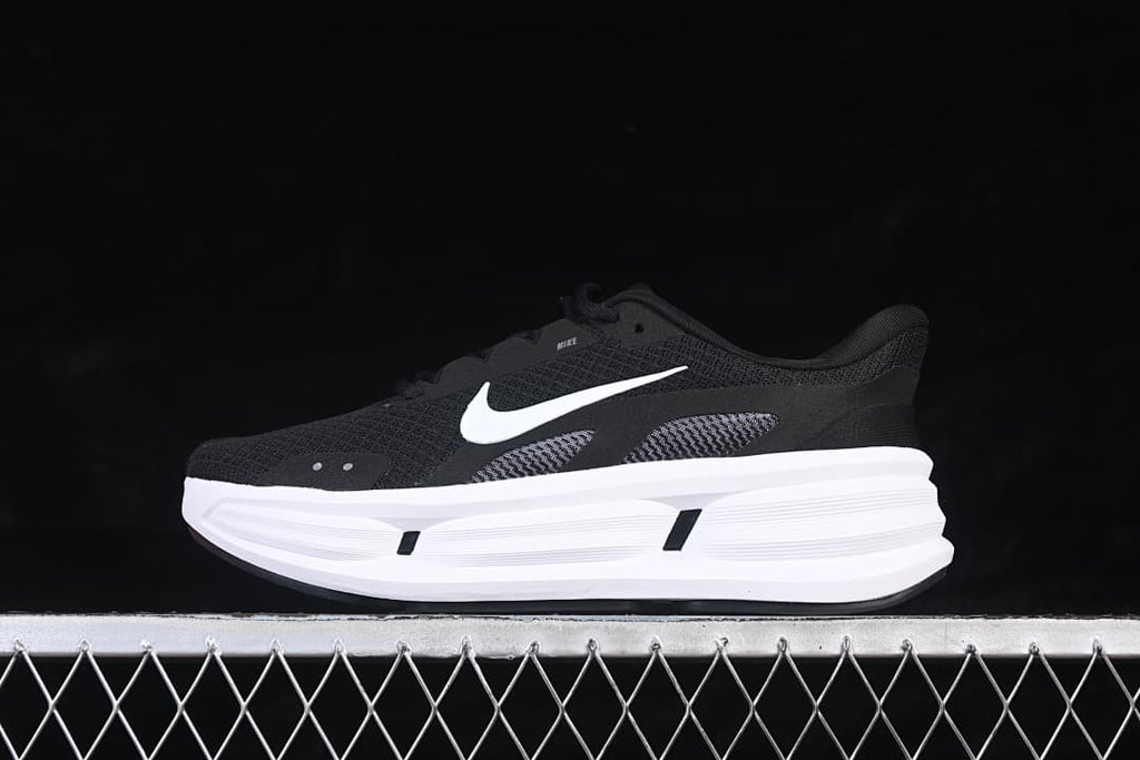 Side view of the Nike Comfort Ride Easyon in black and white, showing the opposite side.