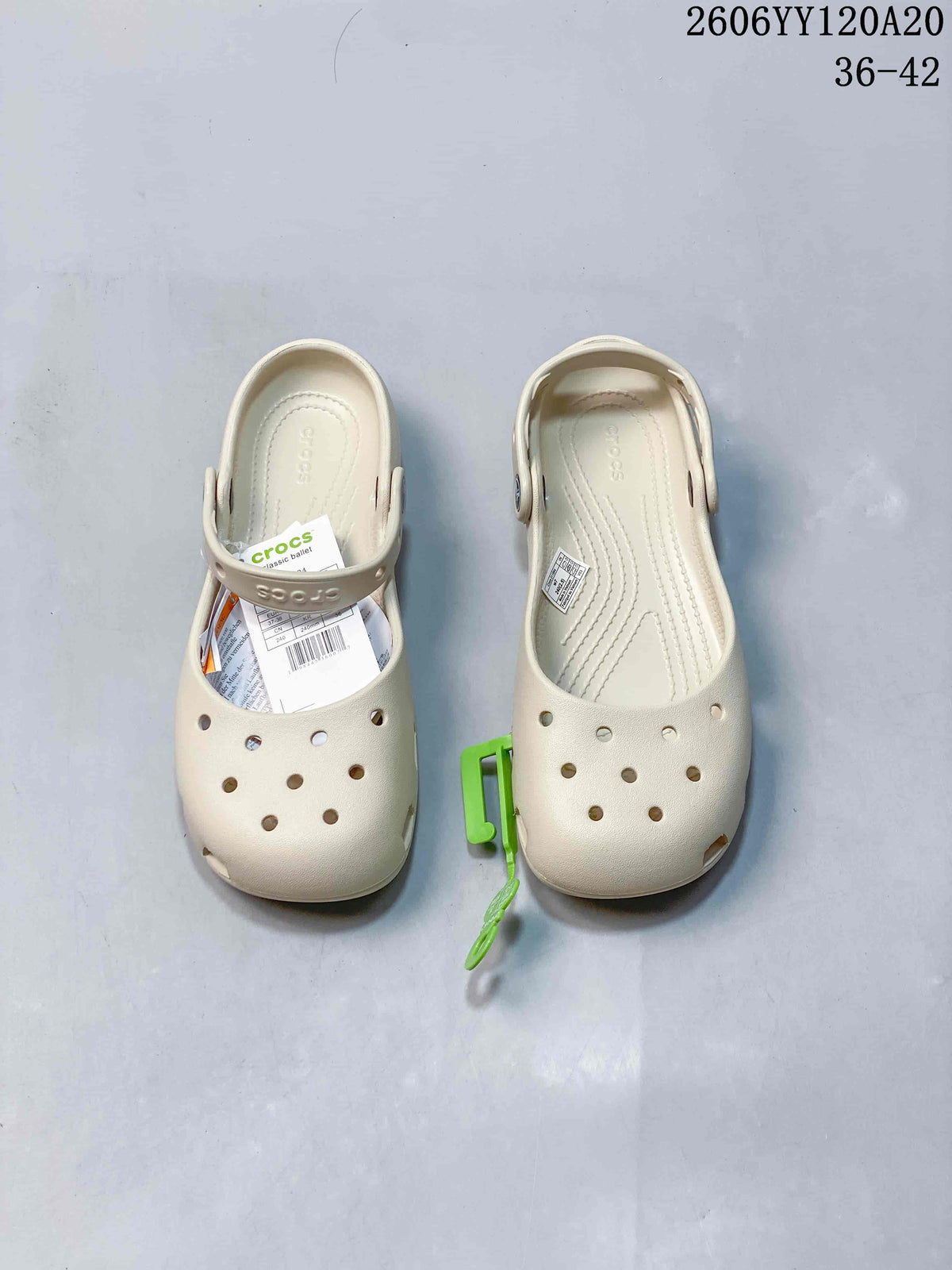 Pair of cream Crocs-style clogs viewed from above, showing perforated toes and heel straps.