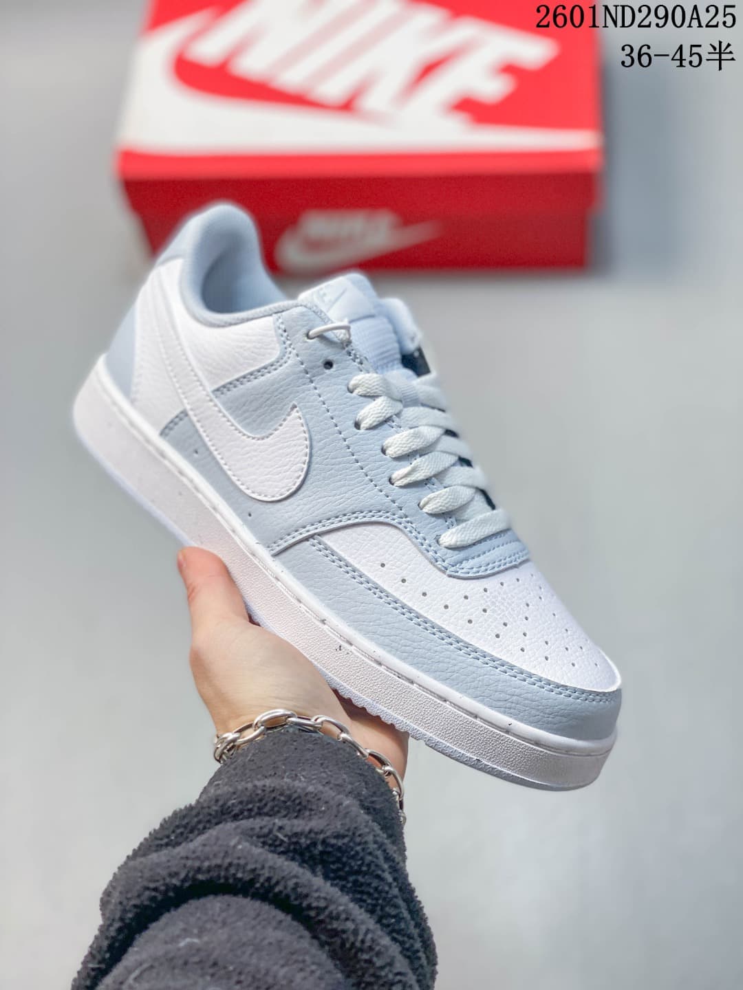 White low-top sneaker with pale blue-gray accents