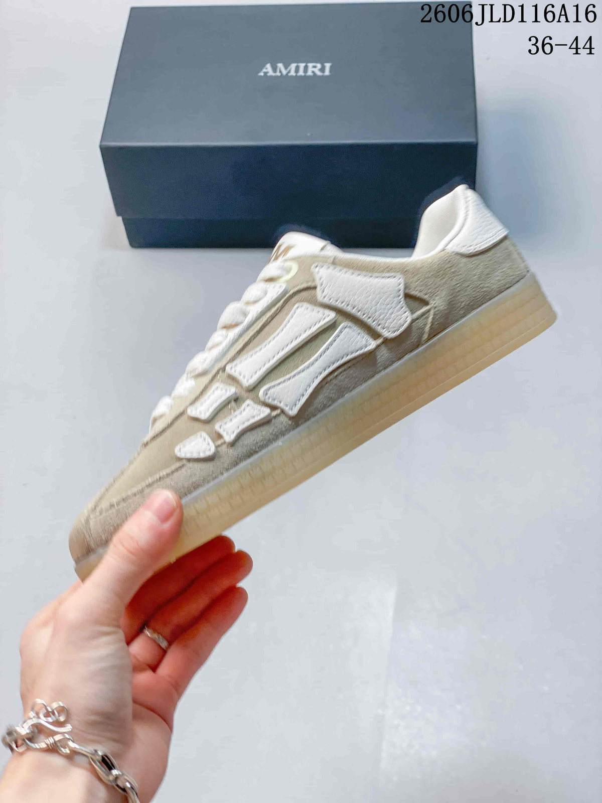 Side profile of the beige-toned low-top sneaker with white bone-shaped appliqués and a translucent sole.