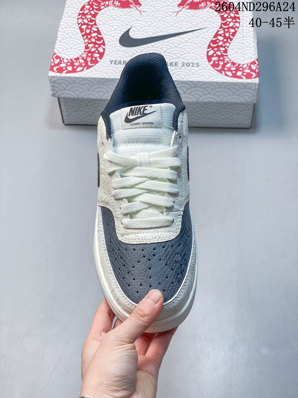 Front view of the sneaker showing its perforated slate-blue toe panel and lace-up closure