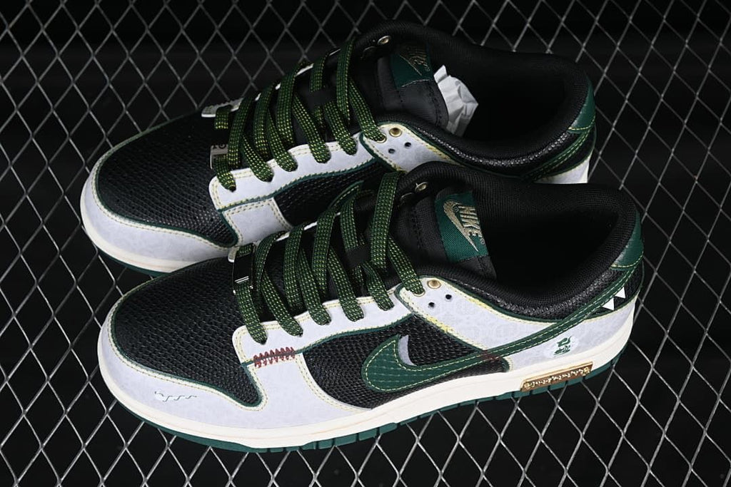 Overhead view of a pair of black, white, and green low-top Nike SB Dunk shoes