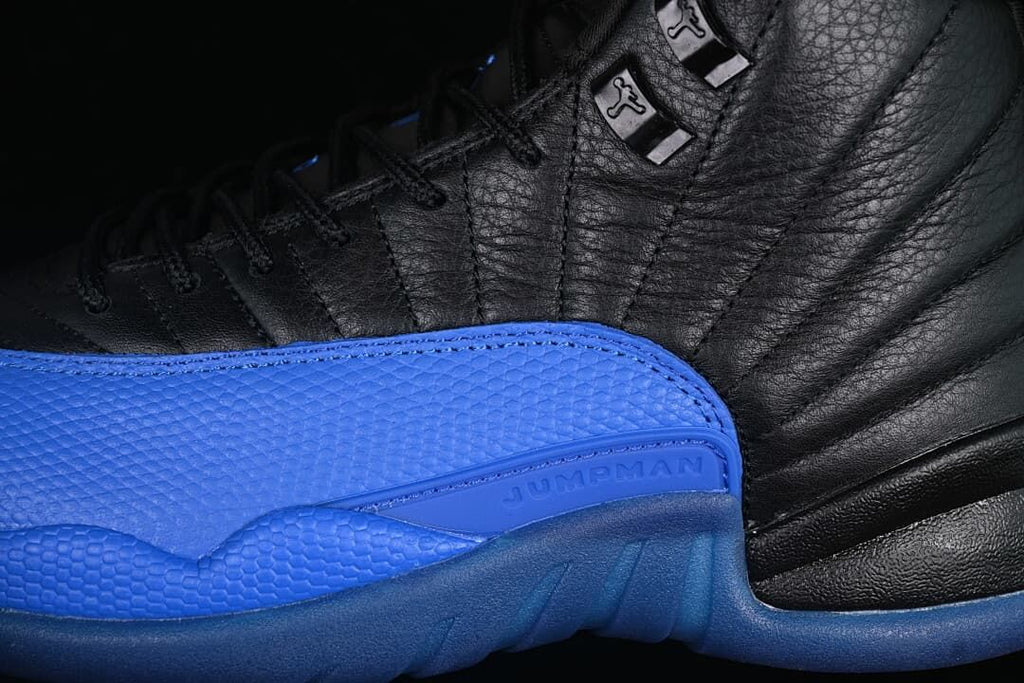 Close-up of black upper, blue side panel, and lace hardware