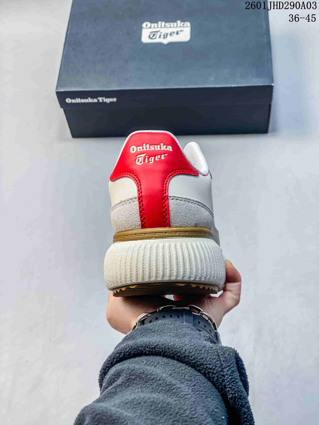 Rear view of the sneaker with a red heel panel and ribbed off-white sole