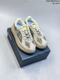 Pair of Onitsuka Tiger Delecity low-top sneakers with multicolored panels on a shoebox