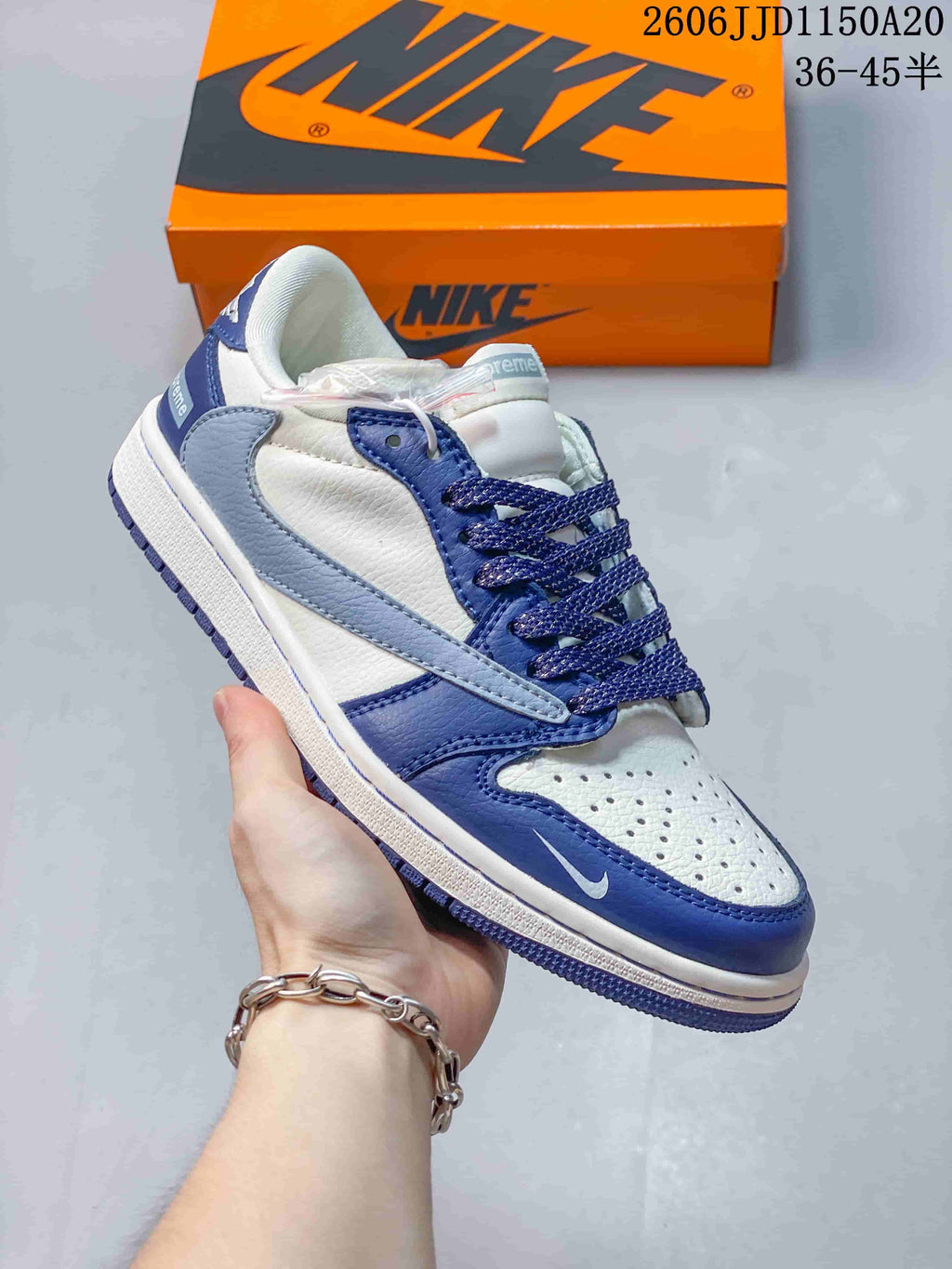 Close view of a blue and white low-top sneaker with contrasting overlays and a pale blue side panel.