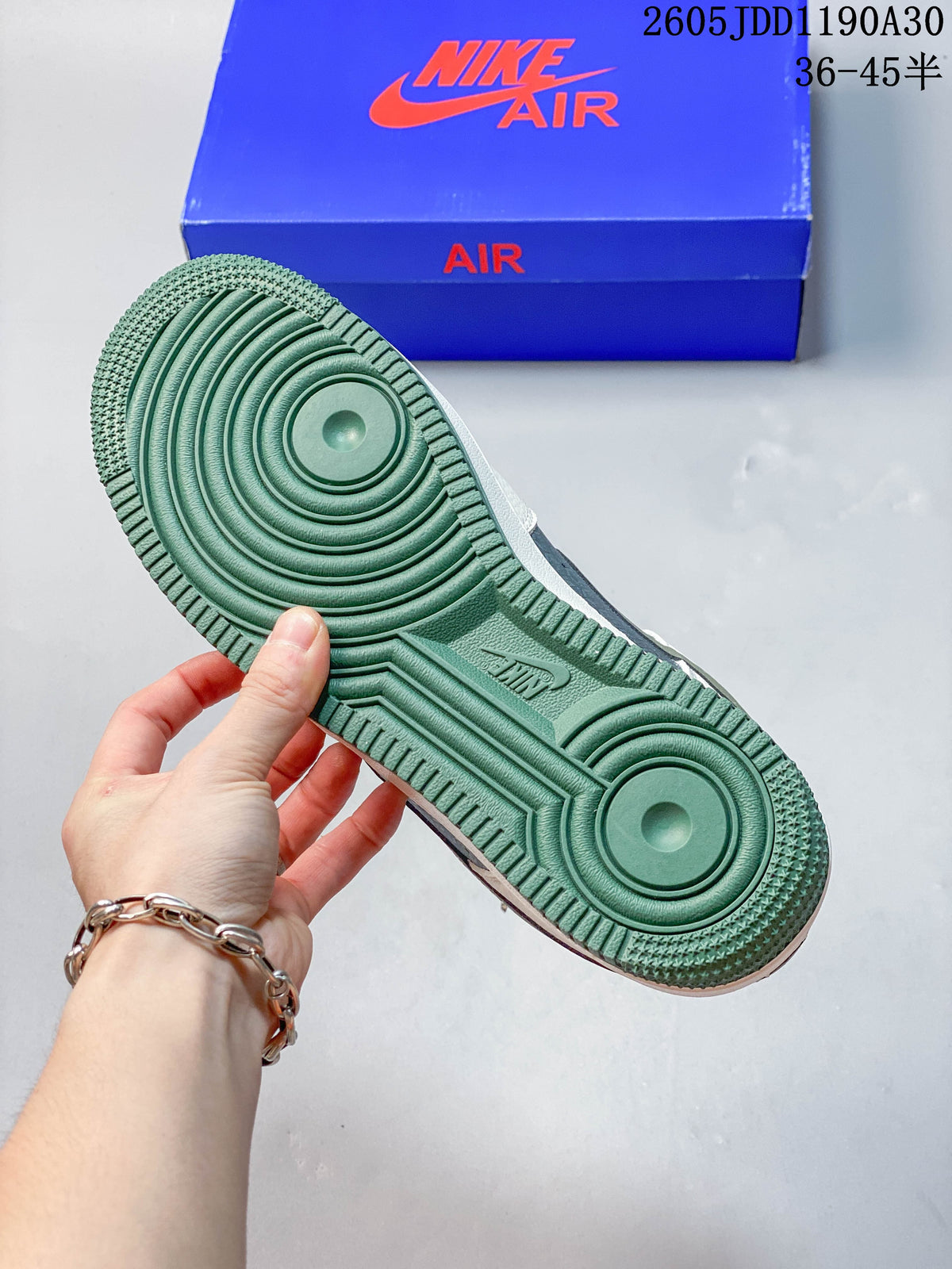 Green outsole of a white Nike Air Force 1 ’07 LV8 sneaker
