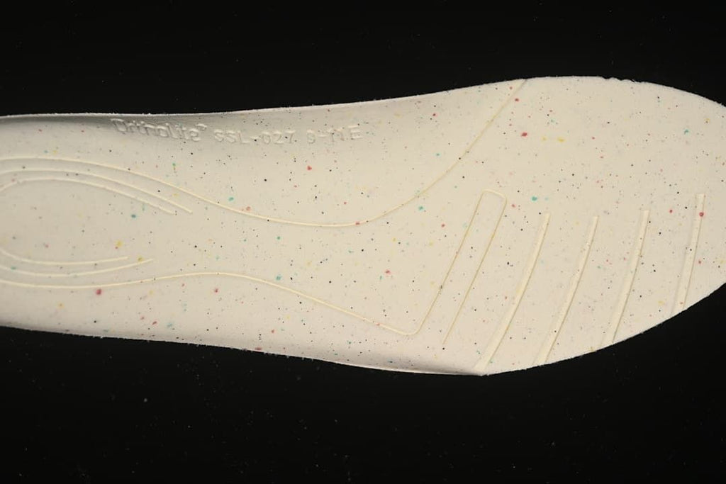 Close-up of the light-colored shoe insole with multicolor speckles