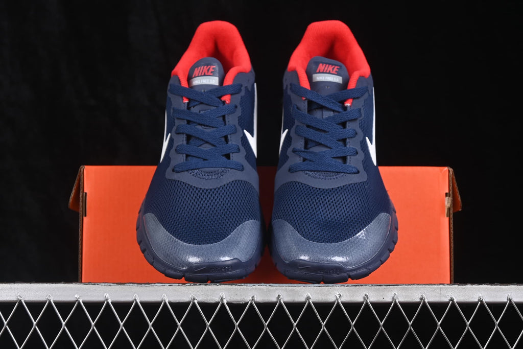 Front view of navy Nike Free 3.0 shoes with red collars, white Swoosh branding, and an orange shoe box.