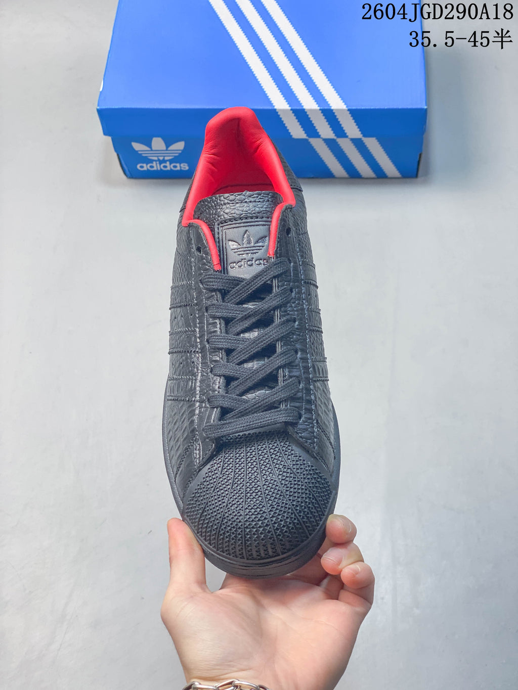 Front view showing the textured shell toe, dark laces, and red lining.